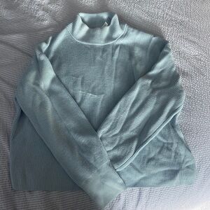 light blue knitted, long sleeve turtleneck, sweater from Lululemon